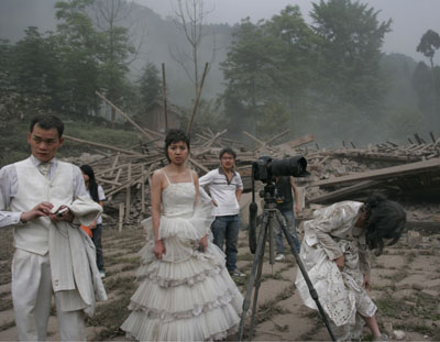 A couple reacts immediately after an earthquake struck during their wedding photo shoot at a deserted catholic seminary in Pengzhou in southwest China's Sichuan province Monday May 12, 2008. Five couples were having wedding photos taken when the earthquak
